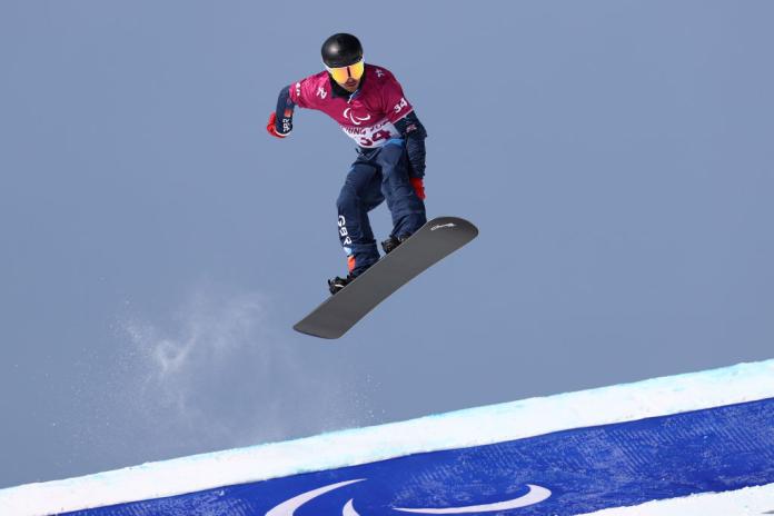 A male Para snowboarder in competition